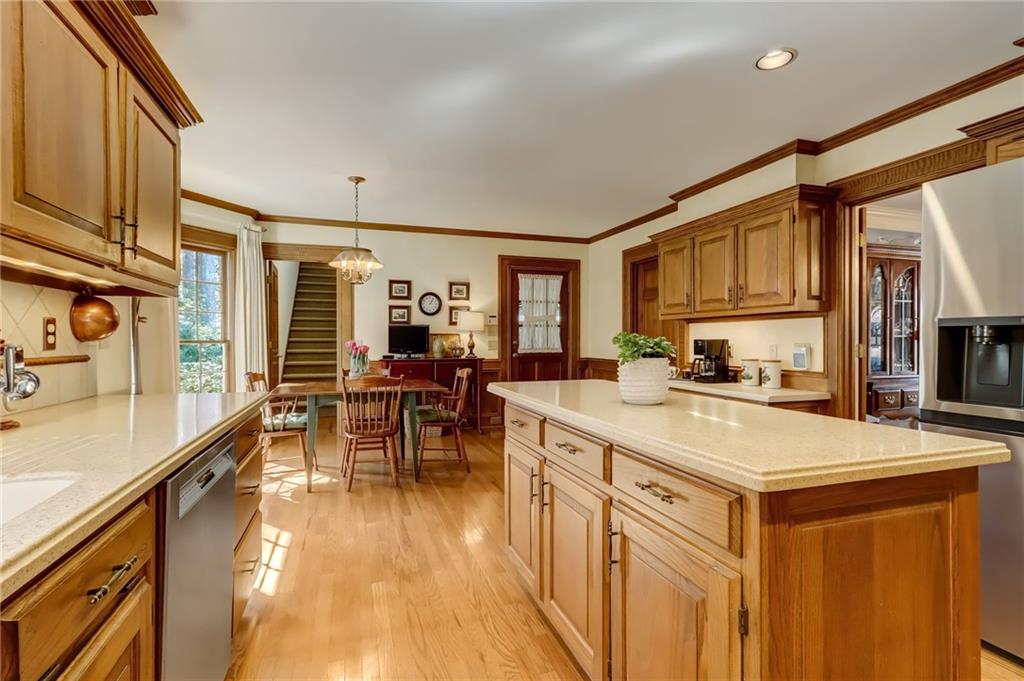 Dining room with plenty of natural light, a chandelier, crown molding, and light hardwood / wood-style floors