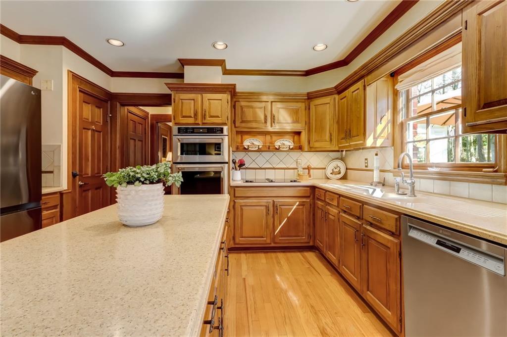 Dining area featuring a chandelier, light hardwood / wood-style flooring, and ornamental molding