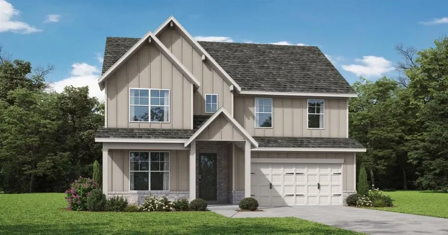 Two-story property featuring a gabled roofline, board and batten siding, and a front-facing attached garage