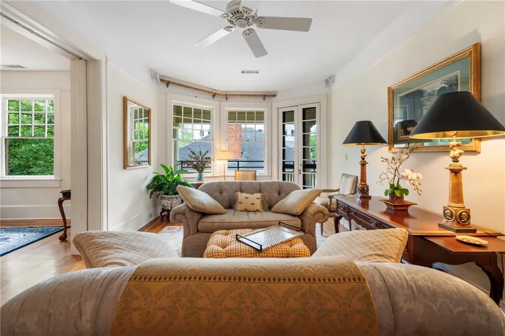 Living room with wood finished floors and a ceiling fan