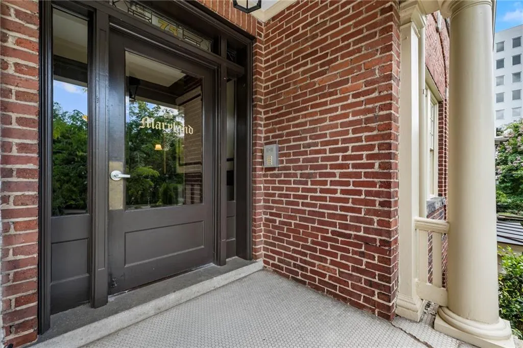 Property entrance featuring brick siding