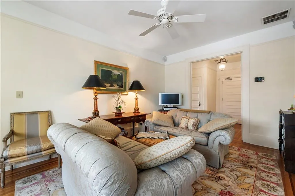 Living room with wood finished floors and ceiling fan