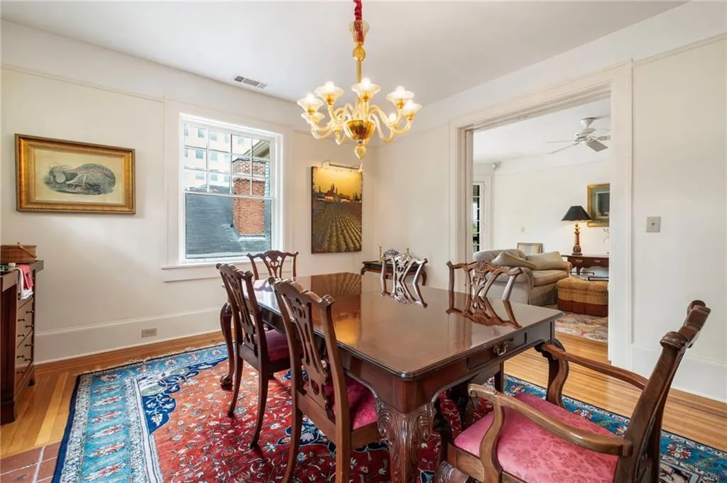 Dining area with hardwood / wood-style floors, a chandelier, and ceiling fan
