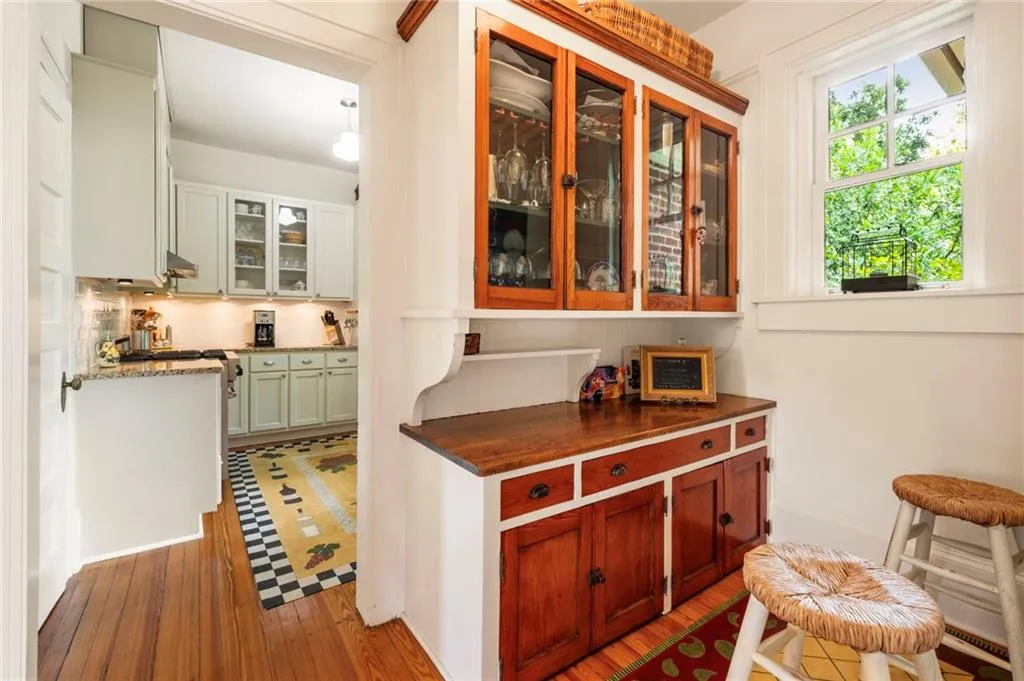 Bar area with decorative backsplash and light wood-style flooring