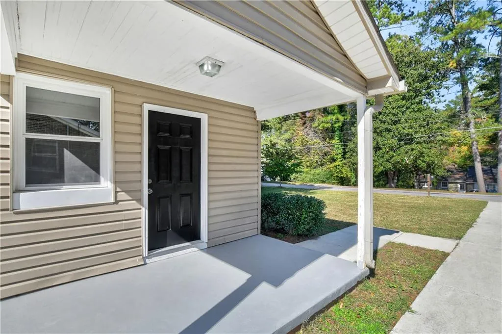 Entrance to property with a lawn