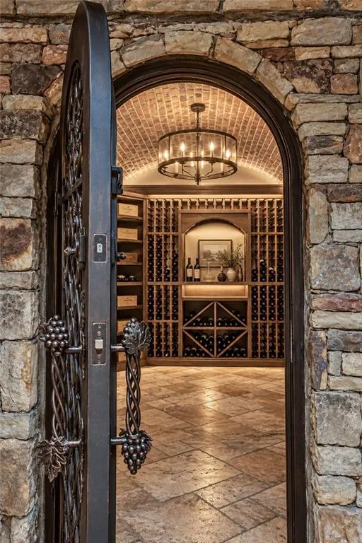 Stone archway entry with a custom wrought iron door