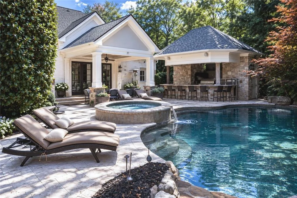 Main level walk out pool with entertaining bar