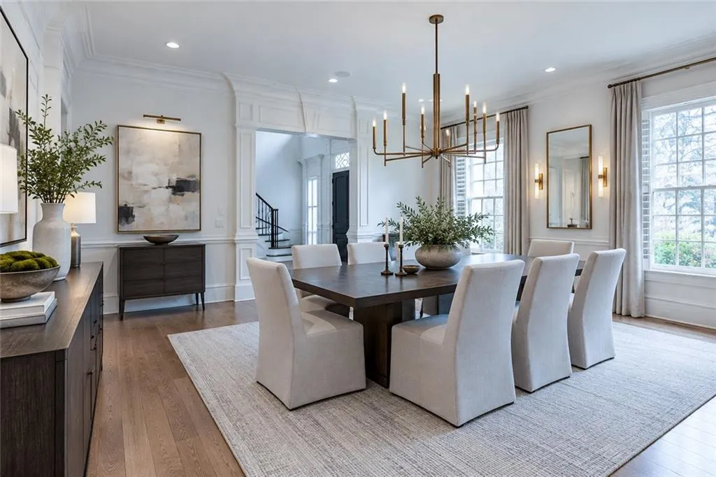 Hardwood-finish flooring, an ornate chandelier, recessed lighting, and large windows with transom details