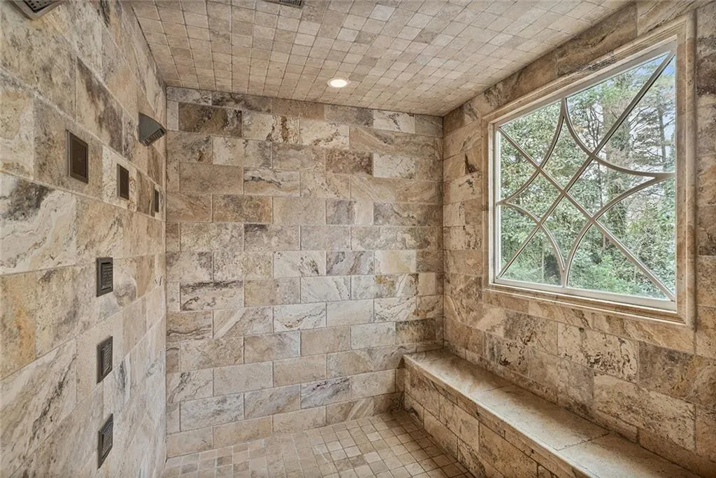 Full bathroom featuring a tile shower and recessed lighting