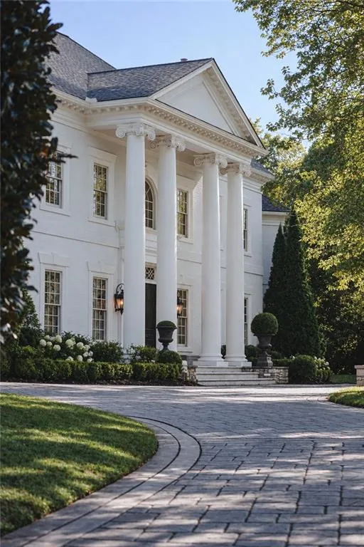 Stately white exterior with grand columns and a prominent pediment
