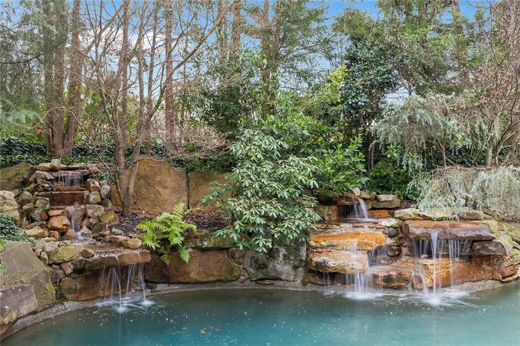 View of pool featuring a small pond