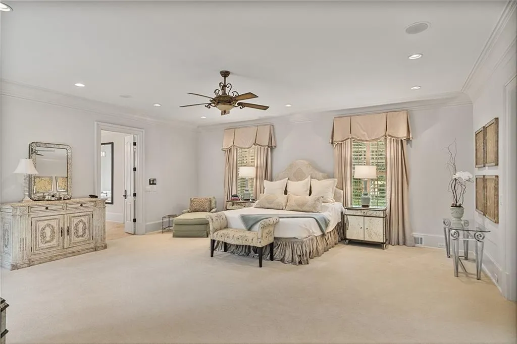 Bedroom with crown molding, light colored carpet, recessed lighting, and ceiling fan