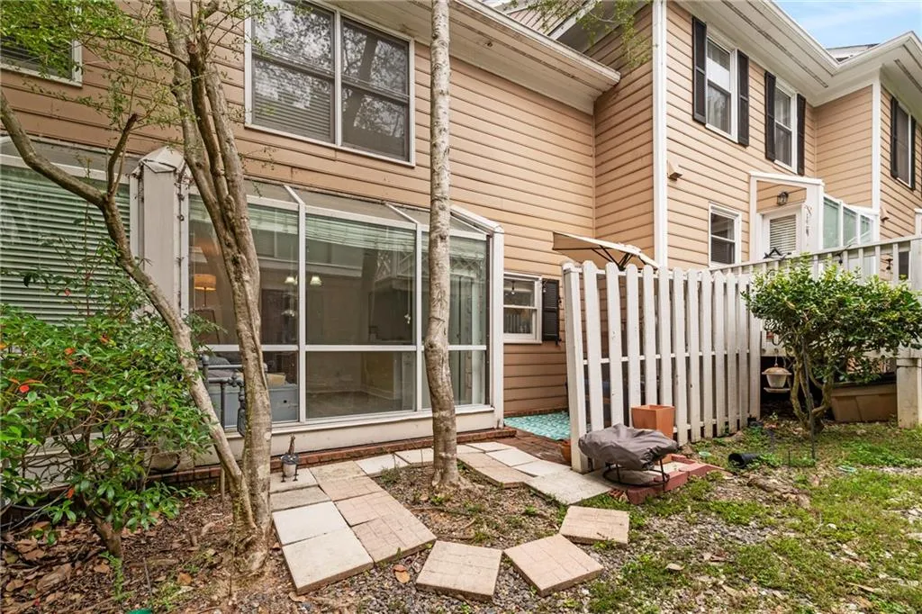 Rear view of house featuring a sunroom