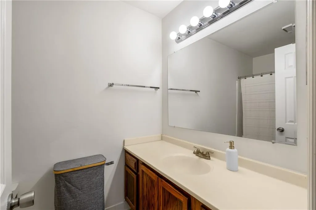 Bathroom with vanity and curtained shower