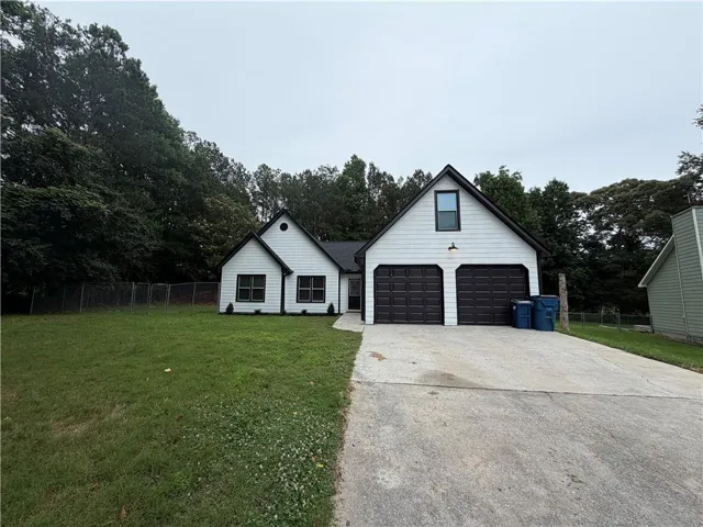 White siding exterior with dark trim accents