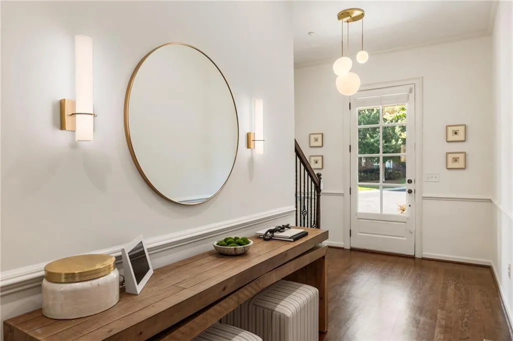 Foyer featuring dark wood finished floors, stairway, and crown molding