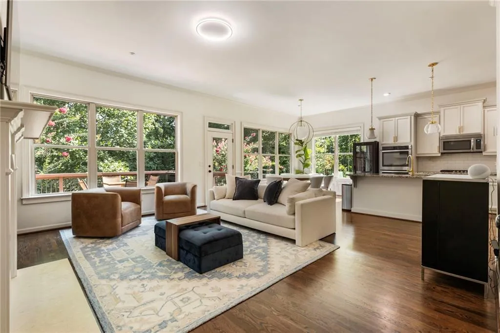 Living area with dark wood-style floors and crown molding
