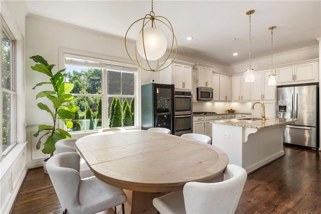 Dining space with crown molding, dark wood-type flooring, recessed lighting, and wine cooler