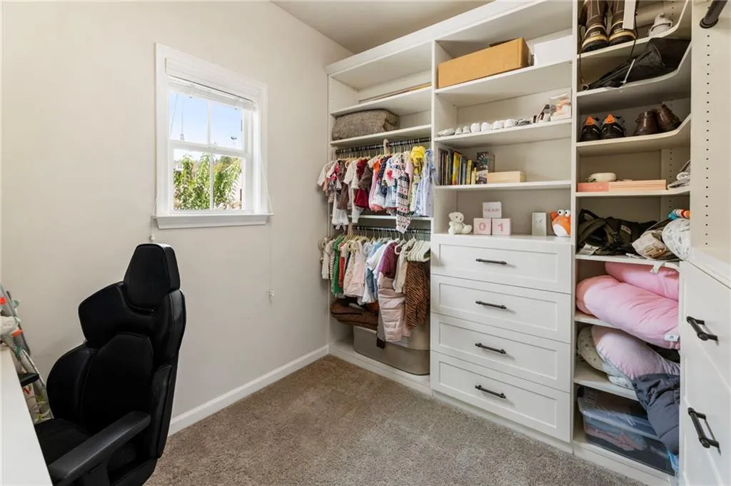 Walk in closet with carpet floors