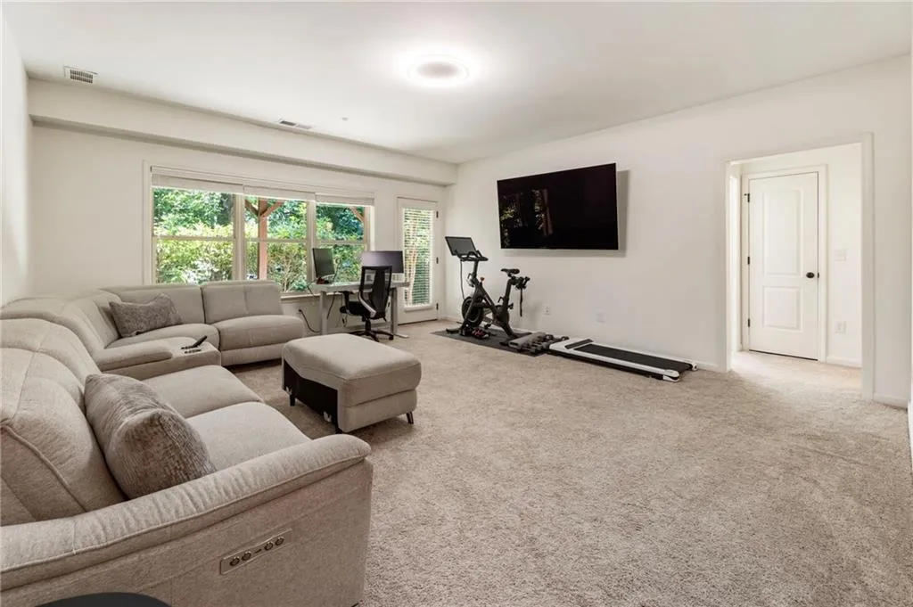 Living room with carpet flooring and baseboards