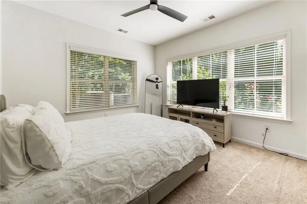 Bedroom featuring carpet flooring and a ceiling fan