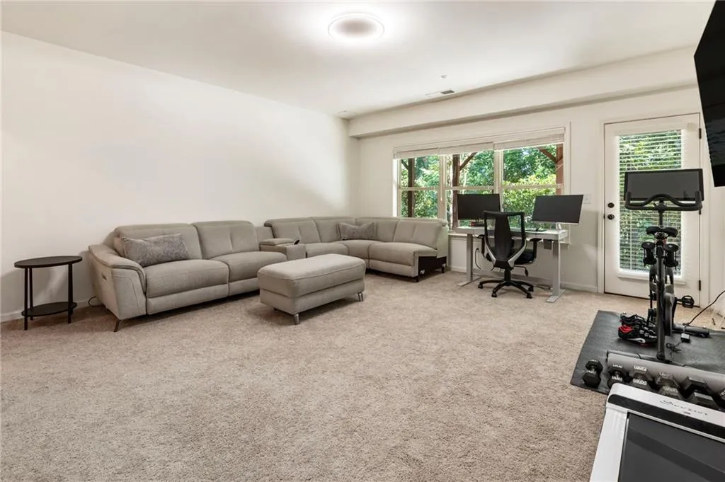 Carpeted living room featuring baseboards
