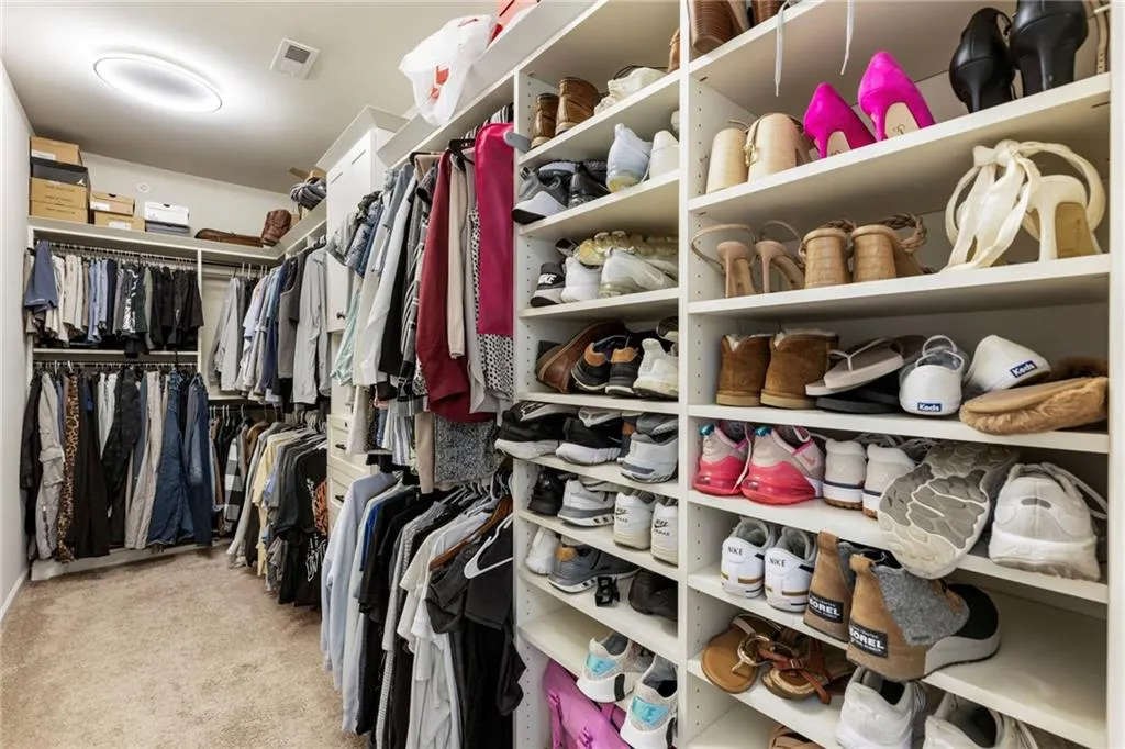 Spacious closet featuring carpet flooring