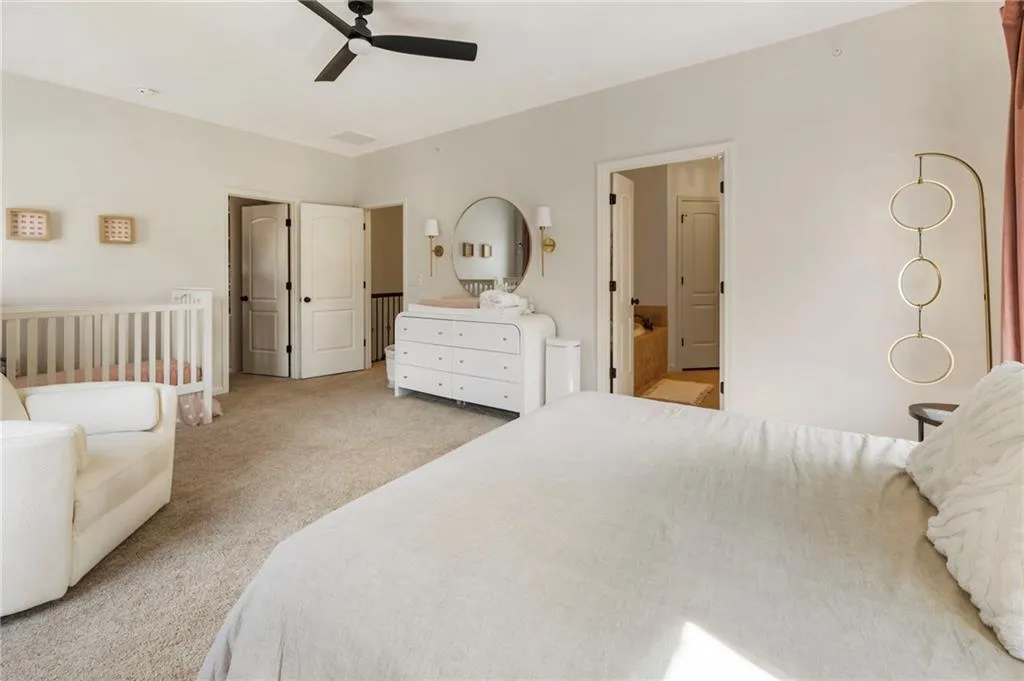 Bedroom with light colored carpet and ceiling fan