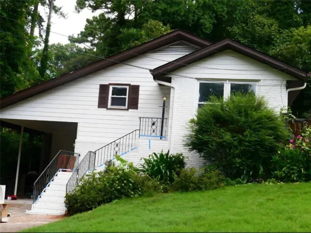 White exterior with a covered carport