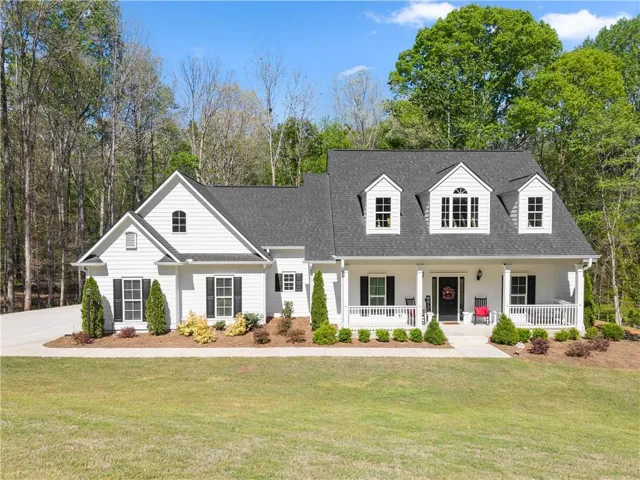 White siding exterior with a dark gray shingle roof