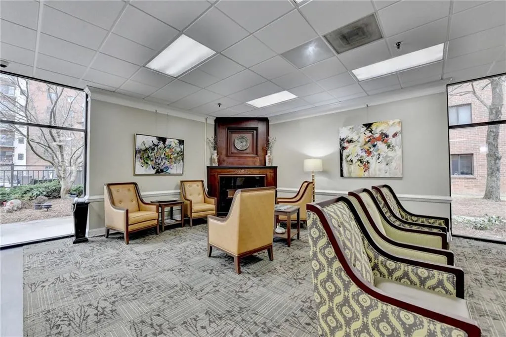 Building lobby featuring floor to ceiling windows and a drop ceiling