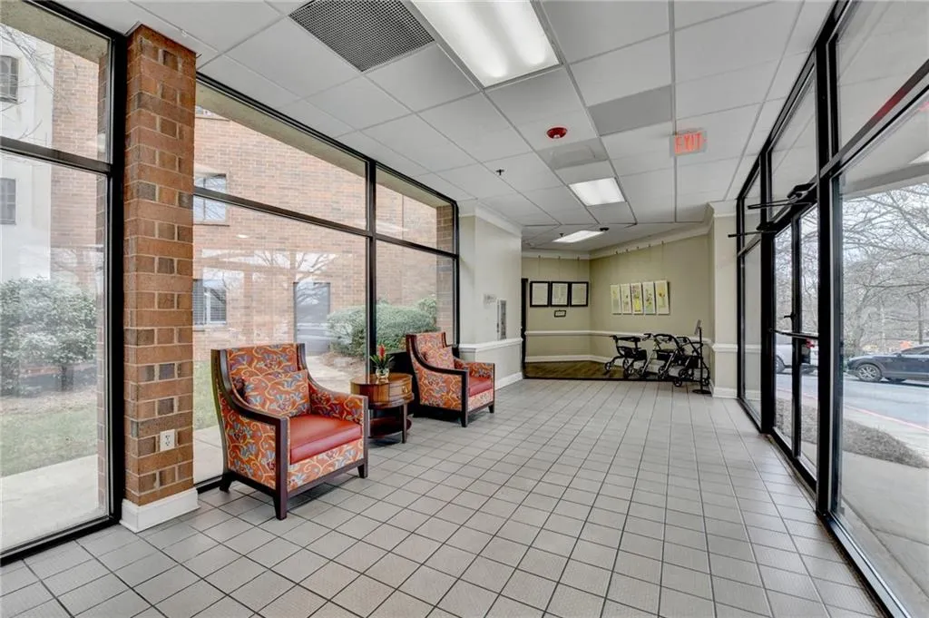 Community lobby with expansive windows and a paneled ceiling