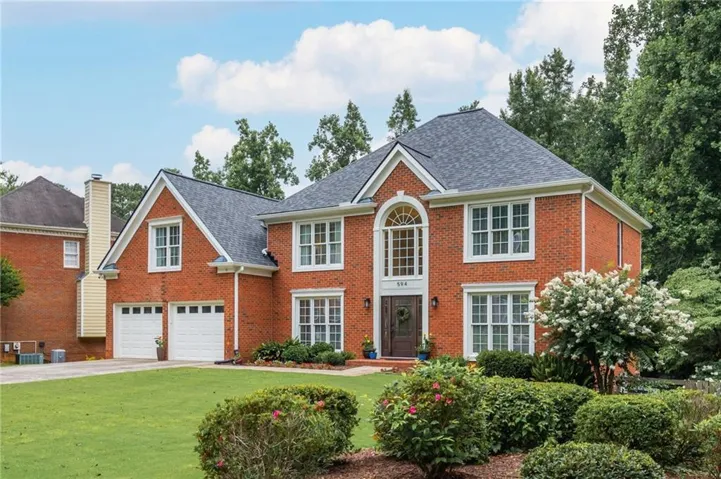 Traditional brick exterior with an arched transom window