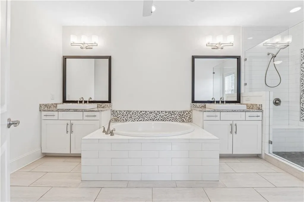 Spa-like primary bath with soaking tub and double vanities