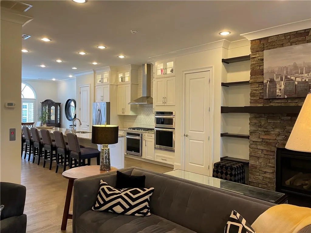 Spacious living area including multi-purpose sunroom - great open space for entertaining.  Two spots for the TV...above the fireplace or on the large wall where it can be seen from the kitchen while cooking.