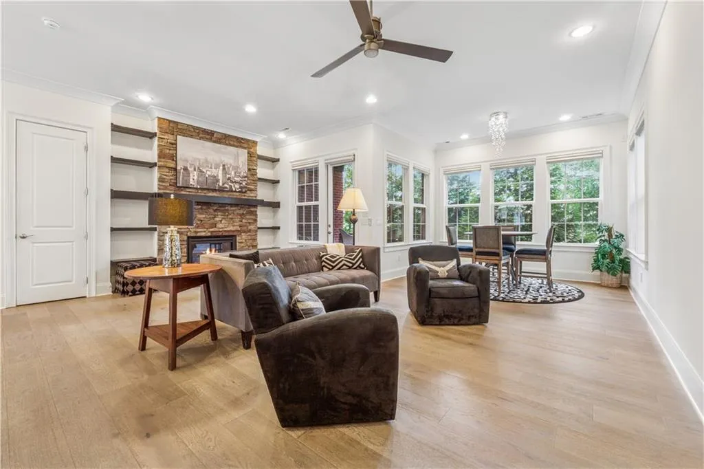 Spacious living area including multi-purpose sunroom - great open space for entertaining.  Two spots for the TV...above the fireplace or on the large wall where it can be seen from the kitchen while cooking. Beautiful wide plank wood floors.