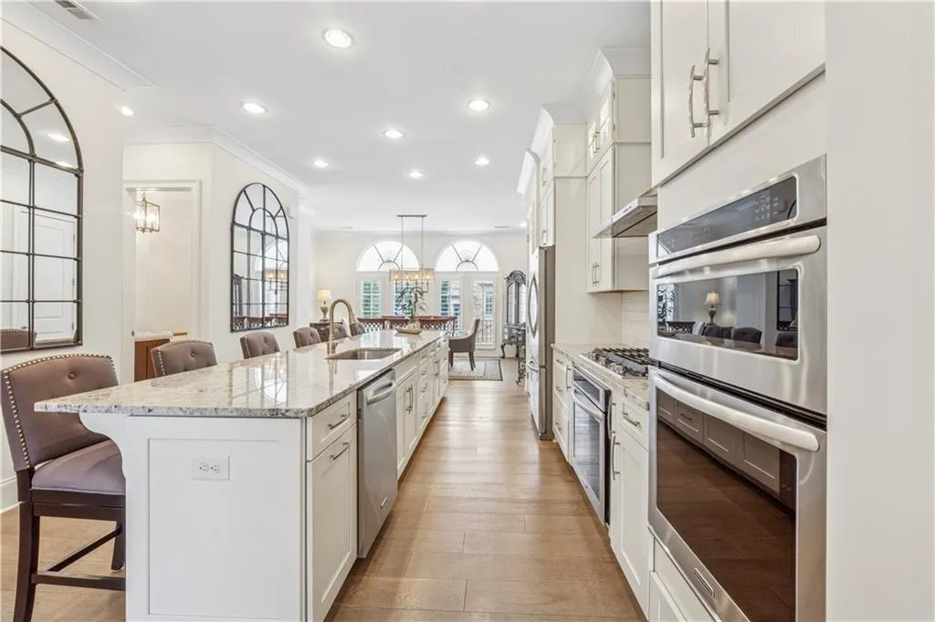 Chef's kitchen has double ovens in addition to convection/microwave oven and 5 burner gas cooktop.