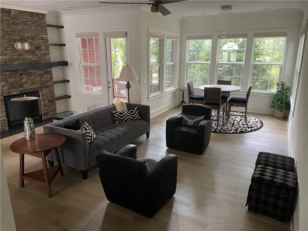 Spacious living area including multi-purpose sunroom - great open space for entertaining.  Two spots for the TV...above the fireplace or on the large wall where it can be seen from the kitchen while cooking.