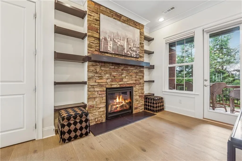 Fireplace with built-ins on both sides.  TV can go above or on opposite wall for viewing from the kitchen. Beautiful wide plank wood floors. Deck access.