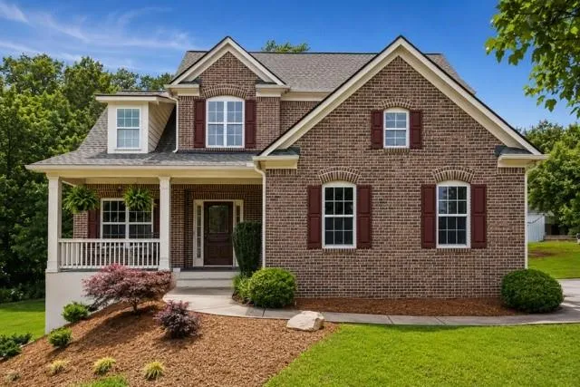 Brick exterior with a gabled roof and covered front porch