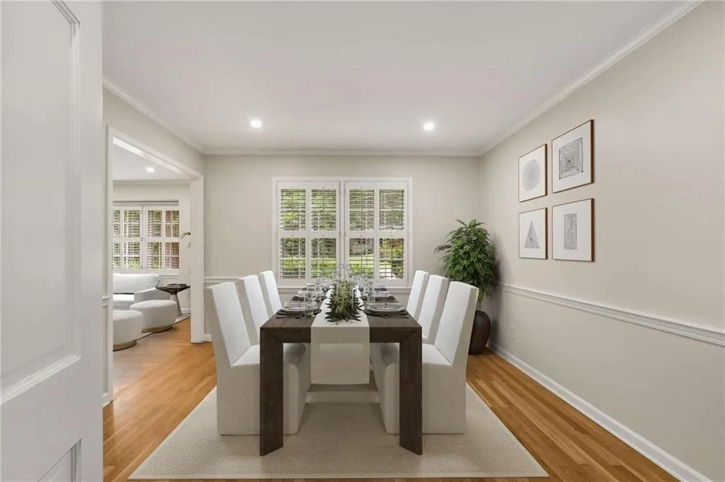 Dining room featuring wood finished floors, crown molding, and recessed lighting