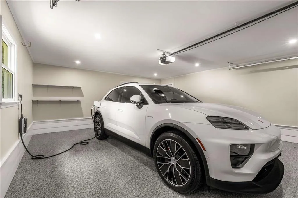 Garage has new flooring and a charging station. Next to the kitchen.