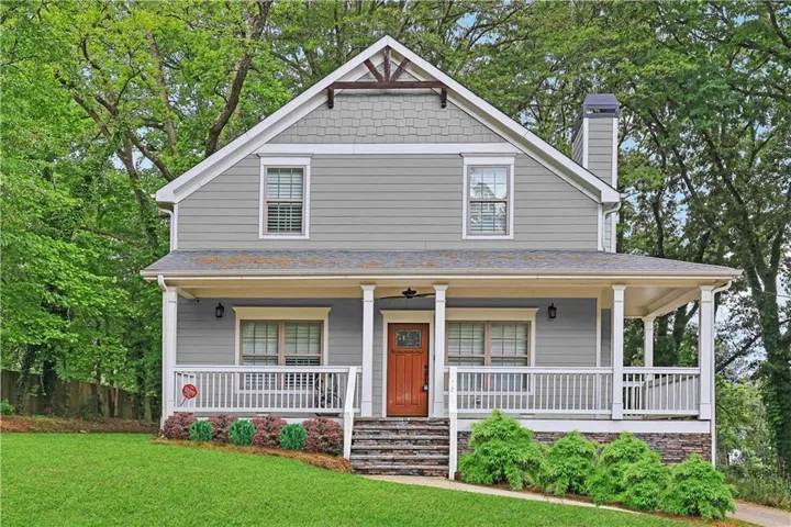 View of front of home with a porch and a front lawn