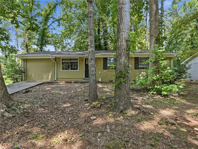 Brick and siding exterior with a dedicated garage entry and a concrete driveway