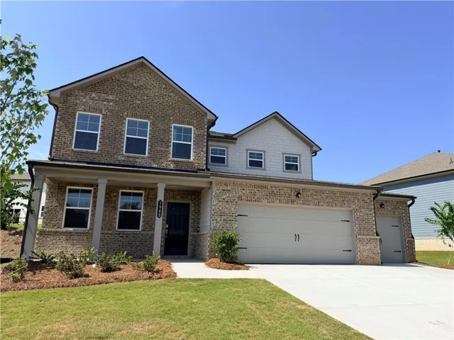 Brick and siding exterior with a covered front porch and a two-car garage