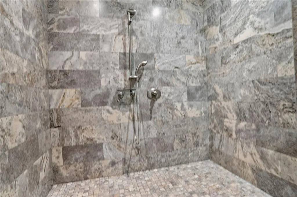 Full bathroom featuring tiled shower