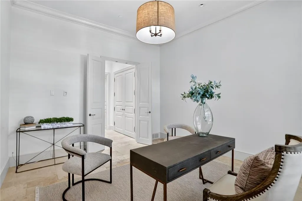 Office with crown molding and baseboards