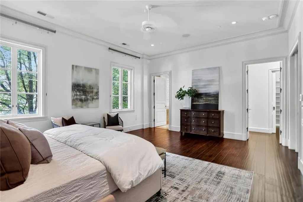 Bedroom featuring crown molding, wood-type flooring, and ceiling fan