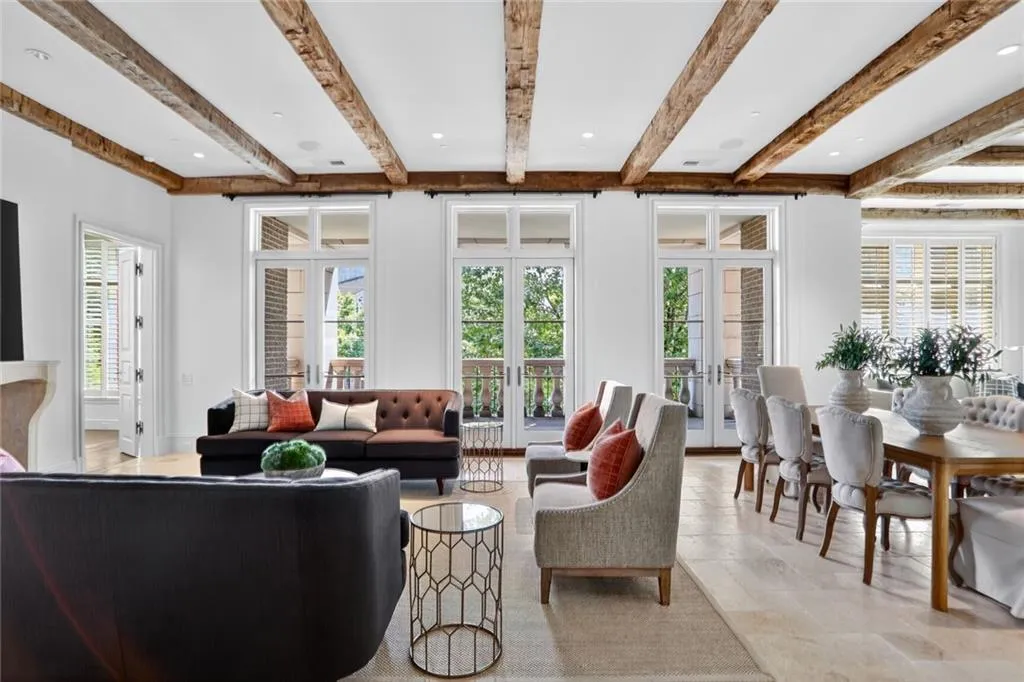 Living area featuring beam ceiling and french doors