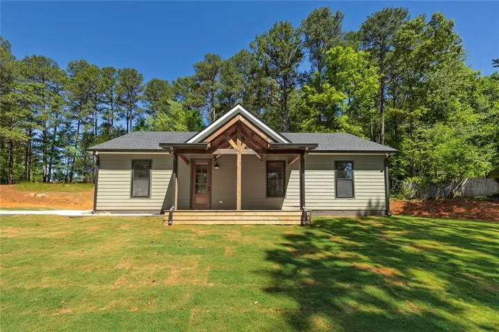 Beautiful new construction ranch with modern farmhouse charm, wood accents, and peaceful wooded surroundings on a private 1.1-acre lot.